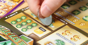 Person playing scratch off card, scratch off game, Depositphotos